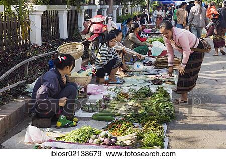 Stock Photo - Vendors selling vegetables on the morning market, Luang Prabang, Laos, Indochina, Asia. Fotosearch