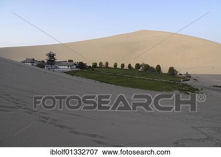 View from the sand dunes of the Gobi Desert to the Crescent Lake with a Chinese Pagoda in Dunhuang, Silk Road, Gansu, China, Asia View Large Photo Image Stock Photo - View from the sand dunes of the Gobi Desert to the Crescent Lake with a Chinese Pagoda in Dunhuang, Silk Road, Gansu, China, Asia. Fotosearch