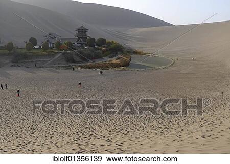View from the sand dunes of the Gobi Desert to the Crescent Lake with Chinese Pagoda in Dunhuang, Silk Road, Gansu, China, Asia View Large Photo Image Stock Photo - View from the sand dunes of the Gobi Desert to the Crescent Lake with Chinese Pagoda in Dunhuang, Silk Road, Gansu, China, Asia. Fotosearch