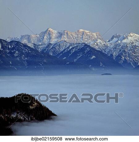 View from the Schlossbergalm alpine pasture across the Vils Valley, Wetterstein Mountains, Upper Bavaria, Bavaria, Germany, Europe View Large Photo Image Stock Photo - View from the Schlossbergalm alpine pasture across the Vils Valley, Wetterstein Mountains, Upper Bavaria, Bavaria, Germany, Europe. Fotosearch