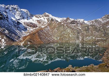 View of the Lake Gruensee, ascent to the Hintere Eggenspitze in the Ultental valley above Lake Weissenbrunn, behind the Weissenbrunnspitze peak, left the Hintere Eggenspitze peak, South Tyrol, Italy, Europe View Large Photo Image Stock Photo - View of the Lake Gruensee, ascent to the Hintere Eggenspitze in the Ultental valley above Lake Weissenbrunn, behind the Weissenbrunnspitze peak, left the Hintere Eggenspitze peak, South Tyrol, Italy, Europe. Fotosearch