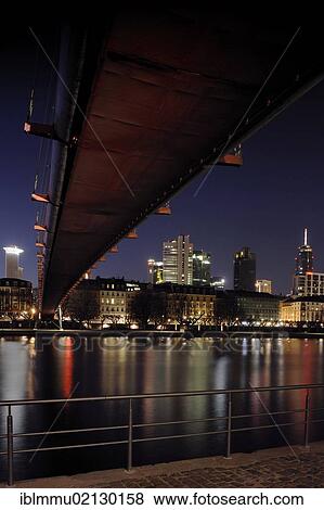 View under Holbeinsteg bridge across the River Main at the Frankfurt skyline at night, Frankfurt am Main, Hesse, Germany, Europe View Large Photo Image Stock Photo - View under Holbeinsteg bridge across the River Main at the Frankfurt skyline at night, Frankfurt am Main, Hesse, Germany, Europe. Fotosearch