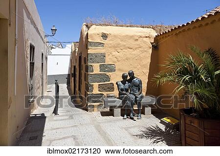 Village square with bronze figures Aspectos del Amor in the historic centre of Agueimes, Gran Canaria, Canary Islands, Spain, Europe View Large Photo Image Stock Image - Village square with bronze figures Aspectos del Amor in the historic centre of Agueimes, Gran Canaria, Canary Islands, Spain, Europe. Fotosearch