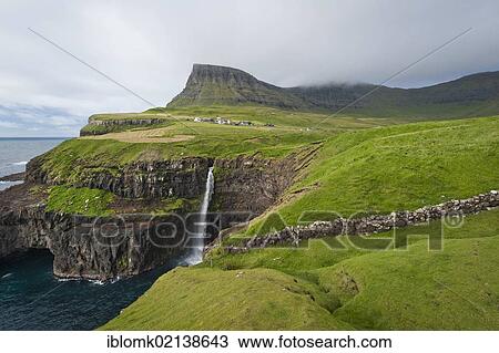 Stock Image - Waterfall into the sea, coast, Gásadalur, Vágar, Faroe Islands, Denmark, North Atlantic, Europe. Fotosearch