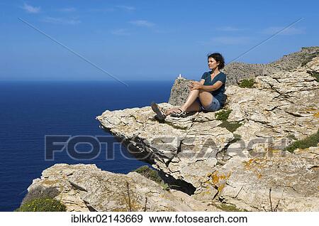 Woman enjoying view at Cap de Formentor, the lighthouse at back, Majorca, Balearic Islands, Spain, Europe View Large Photo Image Stock Photo - Woman enjoying view at Cap de Formentor, the lighthouse at back, Majorca, Balearic Islands, Spain, Europe. Fotosearch