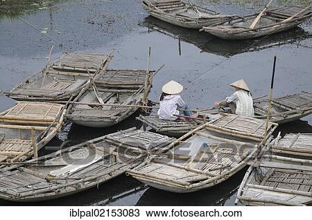 Stock Image - Women, rowing boats, Tra Lai, Vietnam, Southeast Asia, Asia. Fotosearch
