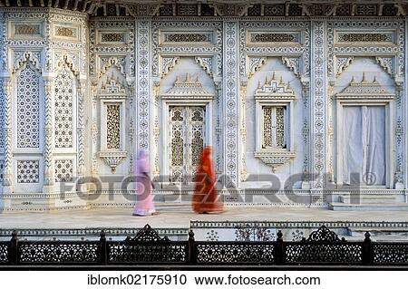 Stock Image - Women wearing colourful saris, marble tomb of the Scindia Dynasty, Shivpuri, Madhya Pradesh, North India, India, Asia. Fotosearch