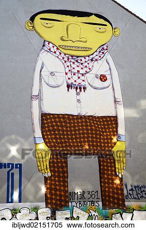 Stock Photography - Yellow Man, street art by Otavio and Gustavo Pandolfo, known as Os Gemeos, Kreuzberg, Berlin, Germany, Europe. Fotosearch