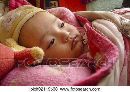 Young baby, few months, little girl, warmly wrapped in thick blankets, Manasarovar Lake, Western Tibet, Ngari province, Tibet, China, Asia View Large Photo Image Stock Photo - Young baby, few months, little girl, warmly wrapped in thick blankets, Manasarovar Lake, Western Tibet, Ngari province, Tibet, China, Asia. Fotosearch
