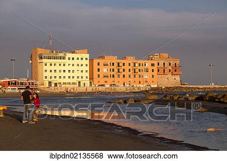 Young couple alone on the deserted beach front of Anzio, in evening light, Lazio, Italy, Europe View Large Photo Image Stock Photo - Young couple alone on the deserted beach front of Anzio, in evening light, Lazio, Italy, Europe. Fotosearch