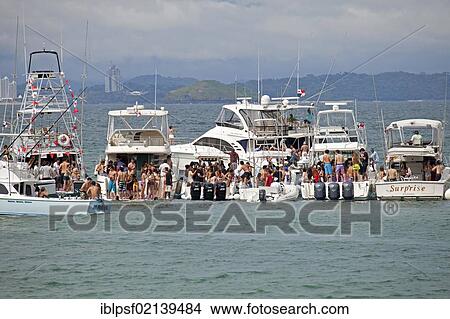 Young people from Panama City celebrating a weekend party on yachts on the island of Isla Taboga, Panama, Central America, North America View Large Photo Image Picture - Young people from Panama City celebrating a weekend party on yachts on the island of Isla Taboga, Panama, Central America, North America. Fotosearch