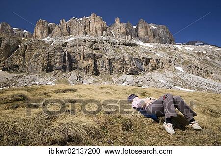 Young woman resting in front of Mount Sella, Dolomites, Italy, Europe View Large Photo Image Stock Image - Young woman resting in front of Mount Sella, Dolomites, Italy, Europe. Fotosearch