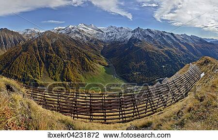 Stock Image - Alpine landscape with avalanche barricades, in the autumn, Olperer glacier with Zillertal Alps behind, Toldern, Schmirntal, Wipptal, Tyrol, Austria, Europe. Fotosearch