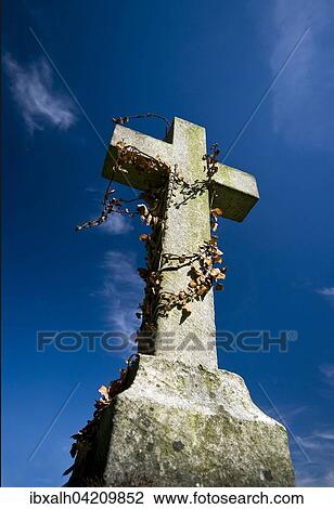 Stock Image - Anglican gravestone against a deep blue sky, Dudley, England, United Kingdom, Europe. Fotosearch