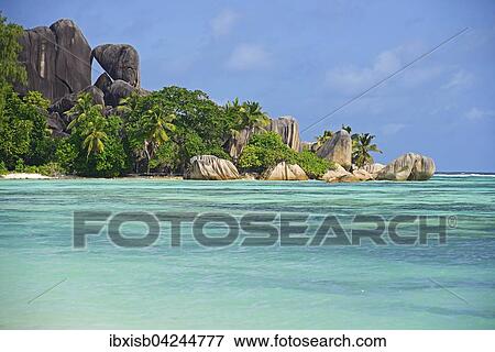 Stock Photo - Anse La Reunion, dreamlike beach, rocks and palm trees, La Digue Island, Seychelles, Africa. Fotosearch