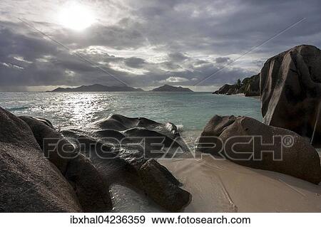 Beach and granite rocks at Anse Source d'Argent with dark clouds, island of Praslin behind, La Digue Island, Seychelles, Africa View Large Photo Image Stock Photo - Beach and granite rocks at Anse Source d'Argent with dark clouds, island of Praslin behind, La Digue Island, Seychelles, Africa. Fotosearch