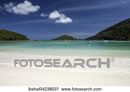 Beautiful white sand beach, turquoise sea, boats lying on beach of Port Launay, Port Launay Marine National Park, Mahe Island, Seychelles, Africa View Large Photo Image Stock Photo - Beautiful white sand beach, turquoise sea, boats lying on beach of Port Launay, Port Launay Marine National Park, Mahe Island, Seychelles, Africa. Fotosearch