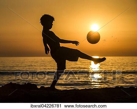 Boy with soccer ball, sunset at the sea, beach, Italy, Europe View Large Photo Image Stock Image - Boy with soccer ball, sunset at the sea, beach, Italy, Europe. Fotosearch