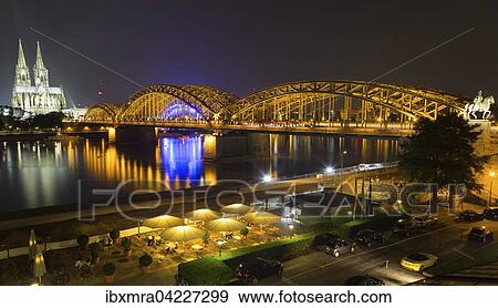 City Panorama at night, Cologne, Hohenzollern Bridge, Cathedral, Philharmonic Hall, Rhein, equestrian statue of Frederick William IV, glass roof and beer garden of the Hyatt Regency Hotel in front, Cologne, North Rhine-Westphalia, Germany, Europe View Large Photo Image Stock Photo - City Panorama at night, Cologne, Hohenzollern Bridge, Cathedral, Philharmonic Hall, Rhein, equestrian statue of Frederick William IV, glass roof and beer garden of the Hyatt Regency Hotel in front, Cologne, North Rhine-Westphalia, Germany, Europe. Fotosearch