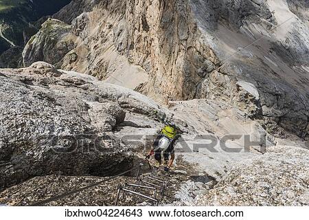 Climber on ferrata West Ridge, Via ferrata di Marmolada, Hans Seyffert path, Marmolada, Dolomites, Alps, Trentino-Alto Adige, Province of South Tyrol, Italy, Europe View Large Photo Image Stock Image - Climber on ferrata West Ridge, Via ferrata di Marmolada, Hans Seyffert path, Marmolada, Dolomites, Alps, Trentino-Alto Adige, Province of South Tyrol, Italy, Europe. Fotosearch