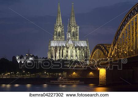 Stock Image - Cologne Cathedral at blue hour, Philharmonie, Hohenzollern Bridge, Rhine, Cologne, North Rhine-Westphalia, Germany, Europe. Fotosearch