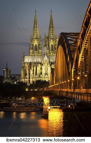 Stock Image - Cologne cathedral at dusk, Philharmonie, Hohenzollern Bridge, Rhine, Cologne, North Rhine-Westphalia, Germany, Europe. Fotosearch