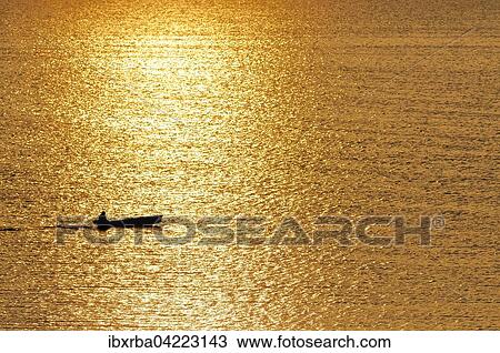 Fisherman in a motorboat at sunset, IAchterwasser, Usedom Island, Mecklenburg-Western Pomerania, Germany, Europe View Large Photo Image Stock Image - Fisherman in a motorboat at sunset, IAchterwasser, Usedom Island, Mecklenburg-Western Pomerania, Germany, Europe. Fotosearch