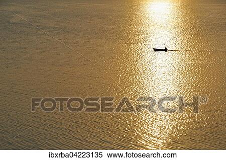 Fisherman in a motorboat at sunset, Achterwasser, Usedom Island, Mecklenburg-Western Pomerania, Germany, Europe View Large Photo Image Stock Photography - Fisherman in a motorboat at sunset, Achterwasser, Usedom Island, Mecklenburg-Western Pomerania, Germany, Europe. Fotosearch