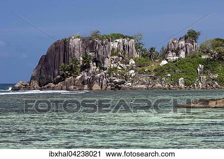 Granite rock with palm trees in sea at Port Glaud, Mahe Island, Seychelles, Africa View Large Photo Image Stock Image - Granite rock with palm trees in sea at Port Glaud, Mahe Island, Seychelles, Africa. Fotosearch