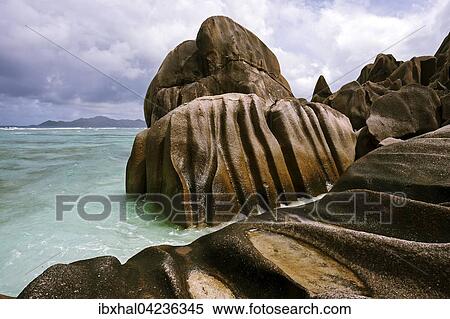 Granite rocks at Anse Source d'Argent, island of Praslin behind, La Digue Island, Seychelles, Africa View Large Photo Image Stock Photography - Granite rocks at Anse Source d'Argent, island of Praslin behind, La Digue Island, Seychelles, Africa. Fotosearch