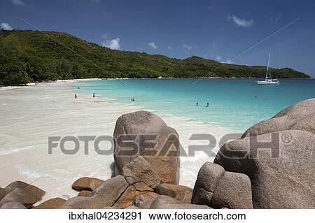 Granite rocks, beach and sailing boat, turquoise sea at Anse Lazio, Praslin Island, Seychelles, Africa View Large Photo Image Stock Image - Granite rocks, beach and sailing boat, turquoise sea at Anse Lazio, Praslin Island, Seychelles, Africa. Fotosearch