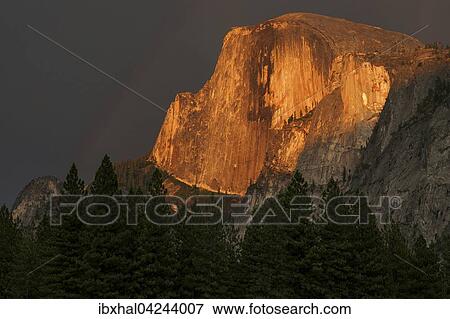 Half Dome illuminated by setting sun, evening light, stormy mood, Yosemite National Park, USA, North America View Large Photo Image Stock Photo - Half Dome illuminated by setting sun, evening light, stormy mood, Yosemite National Park, USA, North America. Fotosearch