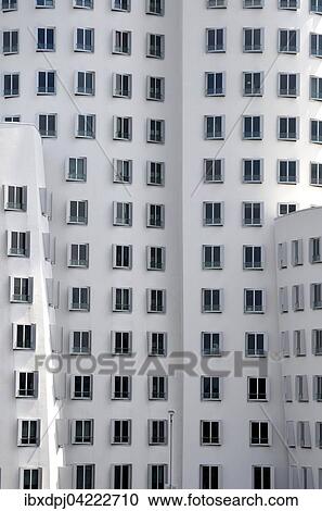 Stock Image - High-rise building facade, windows, Gehry buildings in the MedienHafen, Dusseldorf, North Rhine-Westphalia, Germany, Europe. Fotosearch