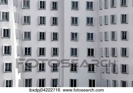Stock Photograph - High-rise building facade, windows, Gehry buildings in the MedienHafen, Dusseldorf, North Rhine-Westphalia, Germany, Europe. Fotosearch