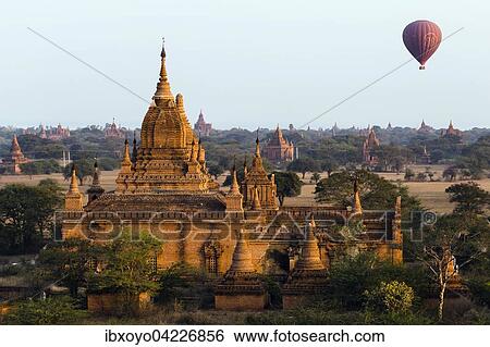 Stock Photograph - Hot air balloon over some of Bagan's 4000 temples, Sulamani Paya temple, Bagan, Myanmar, Asia. Fotosearch