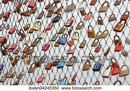 Love locks hanging on metal grid, Heiligenhafen pier, Schleswig-Holstein, Germany, Europe View Large Photo Image Stock Image - Love locks hanging on metal grid, Heiligenhafen pier, Schleswig-Holstein, Germany, Europe. Fotosearch
