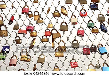 Love locks hanging on metal grid, Heiligenhafen pier, Schleswig-Holstein, Germany, Europe View Large Photo Image Stock Photograph - Love locks hanging on metal grid, Heiligenhafen pier, Schleswig-Holstein, Germany, Europe. Fotosearch