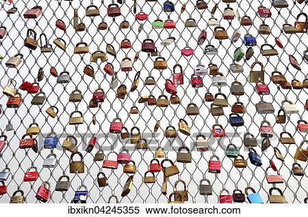 Stock Photography - Love locks hanging on metal grid, Heiligenhafen pier, Schleswig-Holstein, Germany, Europe. Fotosearch