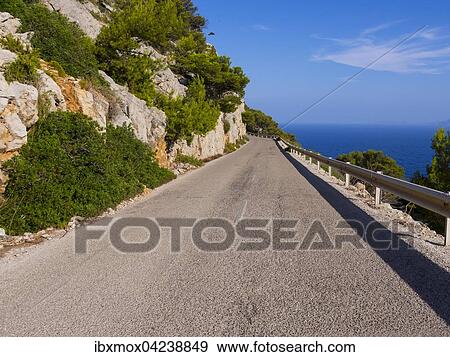Narrow road near Cap de Formentor, Serra de Tramuntana mountain range, Majorca, Balearic Islands, Spain, Europe View Large Photo Image Stock Photo - Narrow road near Cap de Formentor, Serra de Tramuntana mountain range, Majorca, Balearic Islands, Spain, Europe. Fotosearch