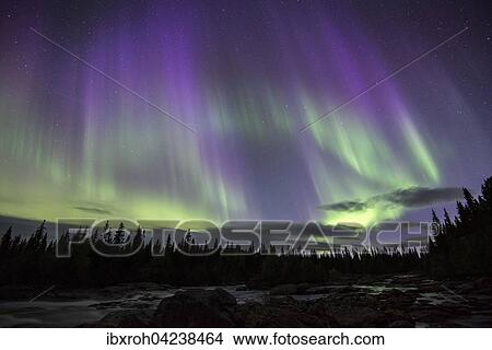 Picture - Northern Lights or Aurora Borealis over the river Gamajahka or Kamajakka, Kvikkjokk, Lapland, Sweden, Europe. Fotosearch