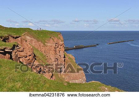 Red rock cliffs and breakwaters in the sea, Heligoland, Schleswig-Holstein, Germany, Europe View Large Photo Image Stock Photograph - Red rock cliffs and breakwaters in the sea, Heligoland, Schleswig-Holstein, Germany, Europe. Fotosearch