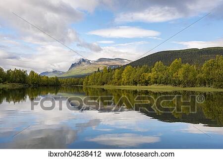Stock Image - Reflection in Tarraatno river, Kvikkjokk, Laponia, Norrbotten, Lapland, Sweden, Europe. Fotosearch