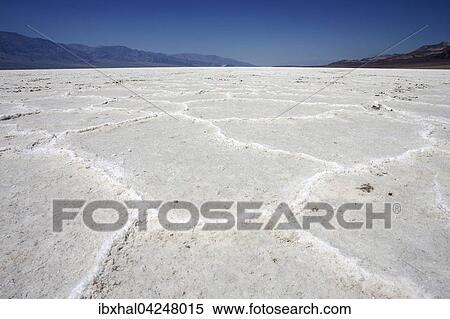 Stock Photography - Salt crust in Badwater Basin salt pan, lowest point in North America, Panamint Range left, Black Mountains, Death Valley, Mojave Desert, California, USA, North America. Fotosearch