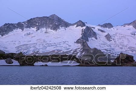 Stock Photo - Schwarzsee lake in Zemmgrund, Ginzling behind, sunrise, Zillertal, Tyrol, Austria, Europe. Fotosearch