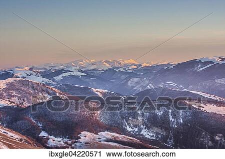 Stock Image - Sibillini Mountains, or Sibylline Mountains in the snow at sunset, aerial view from Mount Cucco, Monte Cucco in the Apennines, Marche and Umbria, Italy, Europe. Fotosearch