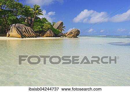 Source d'Argent beach, rocks and palm trees, La Digue Island, Seychelles, Africa View Large Photo Image Stock Photo - Source d'Argent beach, rocks and palm trees, La Digue Island, Seychelles, Africa. Fotosearch