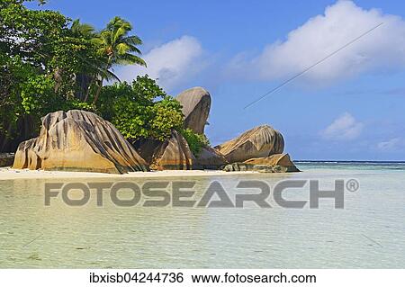 Stock Photograph - Source d'Argent beach, rocks and palm trees, La Digue Island, Seychelles, Africa. Fotosearch