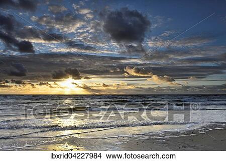 Sunset with clouds on the beach, North Sea, Texel, West Frisian Islands, Province of North Holland, The Netherlands, Europe View Large Photo Image Picture - Sunset with clouds on the beach, North Sea, Texel, West Frisian Islands, Province of North Holland, The Netherlands, Europe. Fotosearch