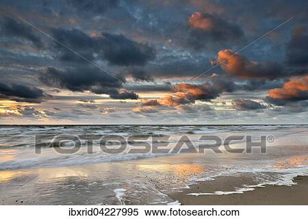 Sunset with clouds on the beach, North Sea, Texel, West Frisian Islands, Province of North Holland, The Netherlands, Europe View Large Photo Image Stock Photography - Sunset with clouds on the beach, North Sea, Texel, West Frisian Islands, Province of North Holland, The Netherlands, Europe. Fotosearch