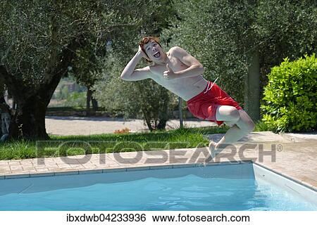 Teenage boy jumping in a swimming pool, happy View Large Photo Image Stock Photograph - Teenage boy jumping in a swimming pool, happy. Fotosearch